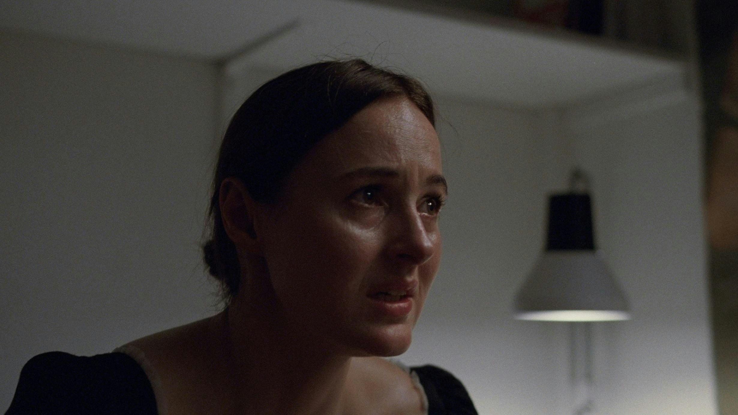 A young woman holding a severed head in House, 1977