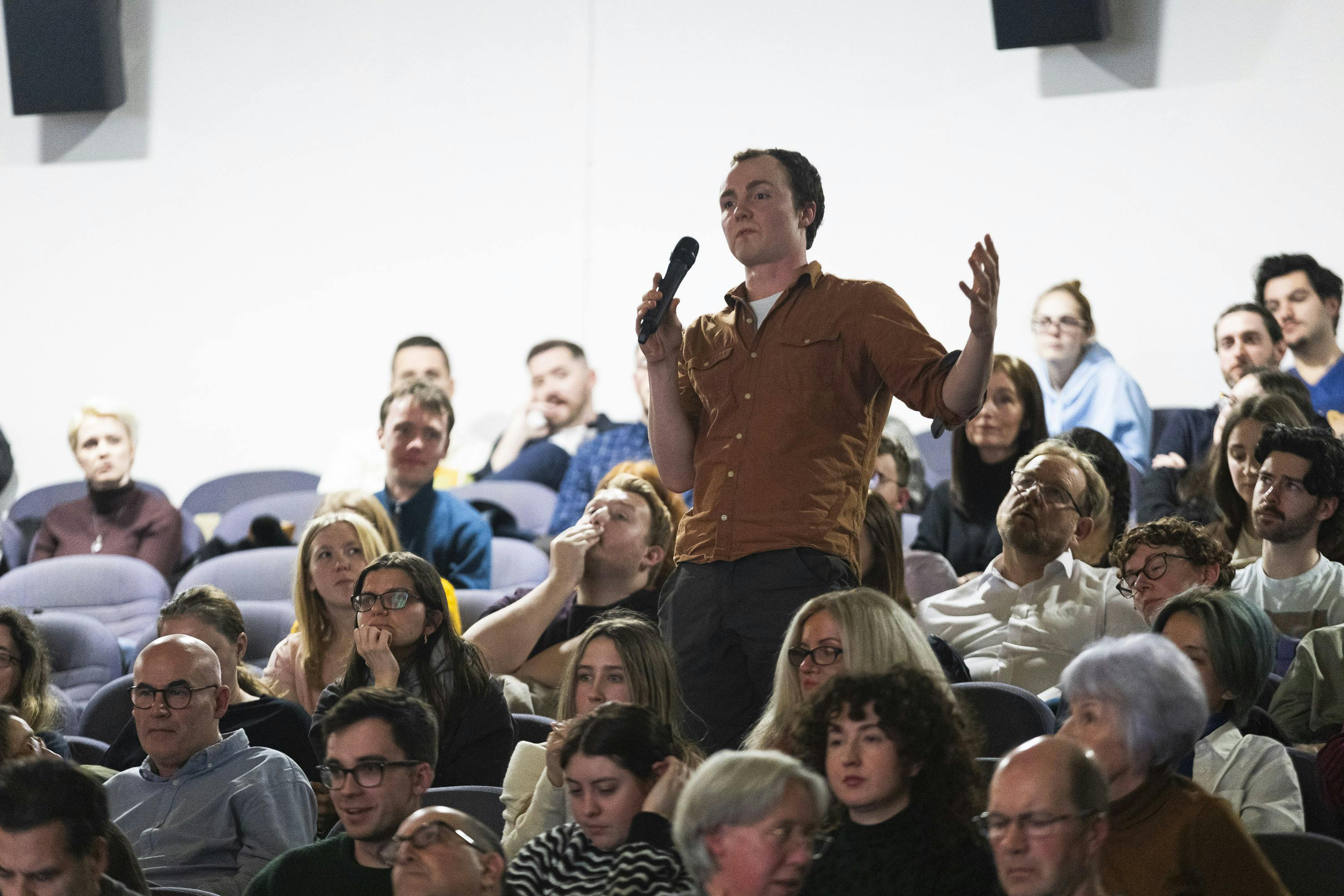 Audience cheering inside a theatre
