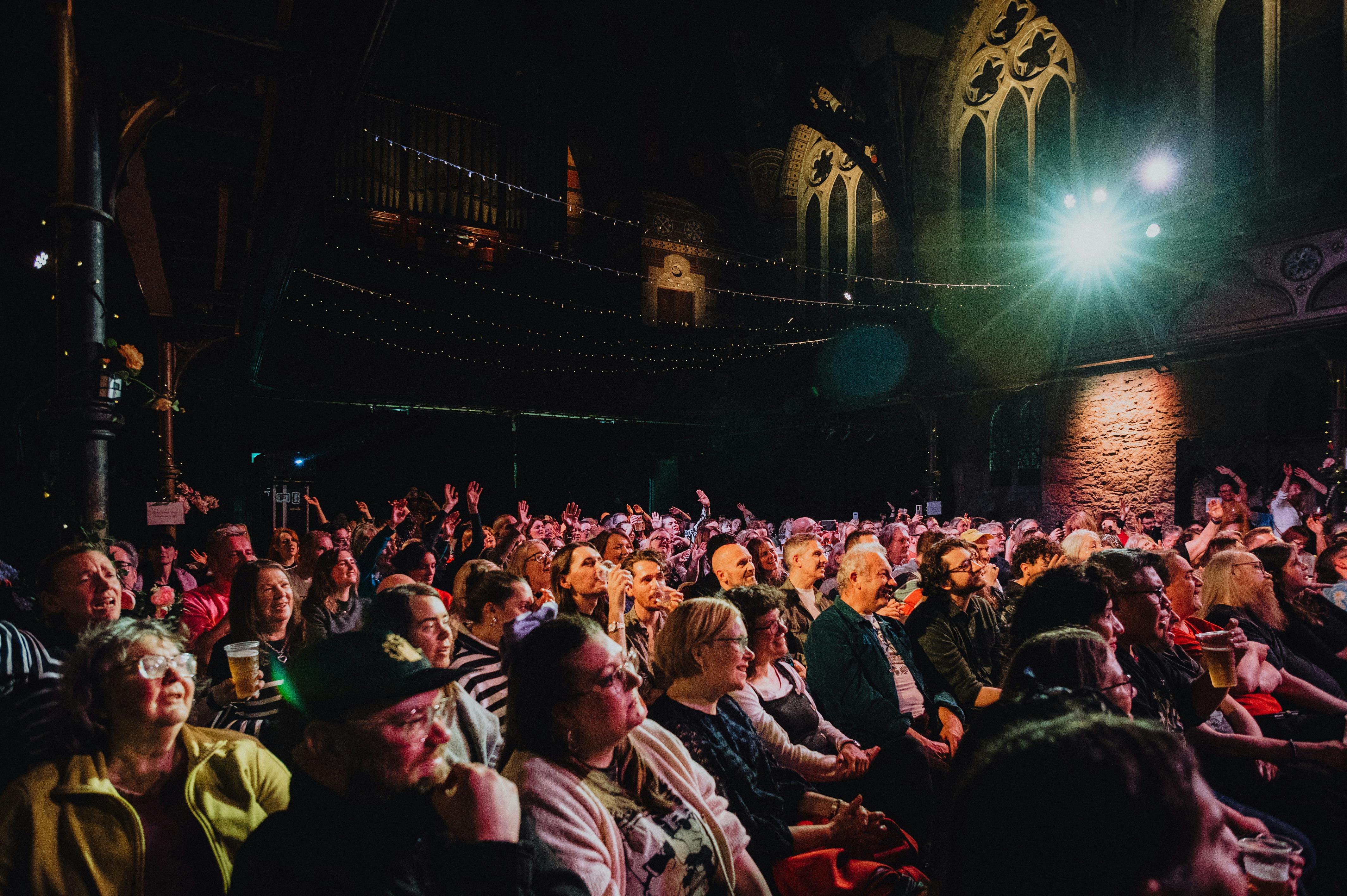 Large outdoor crowd watching a performance