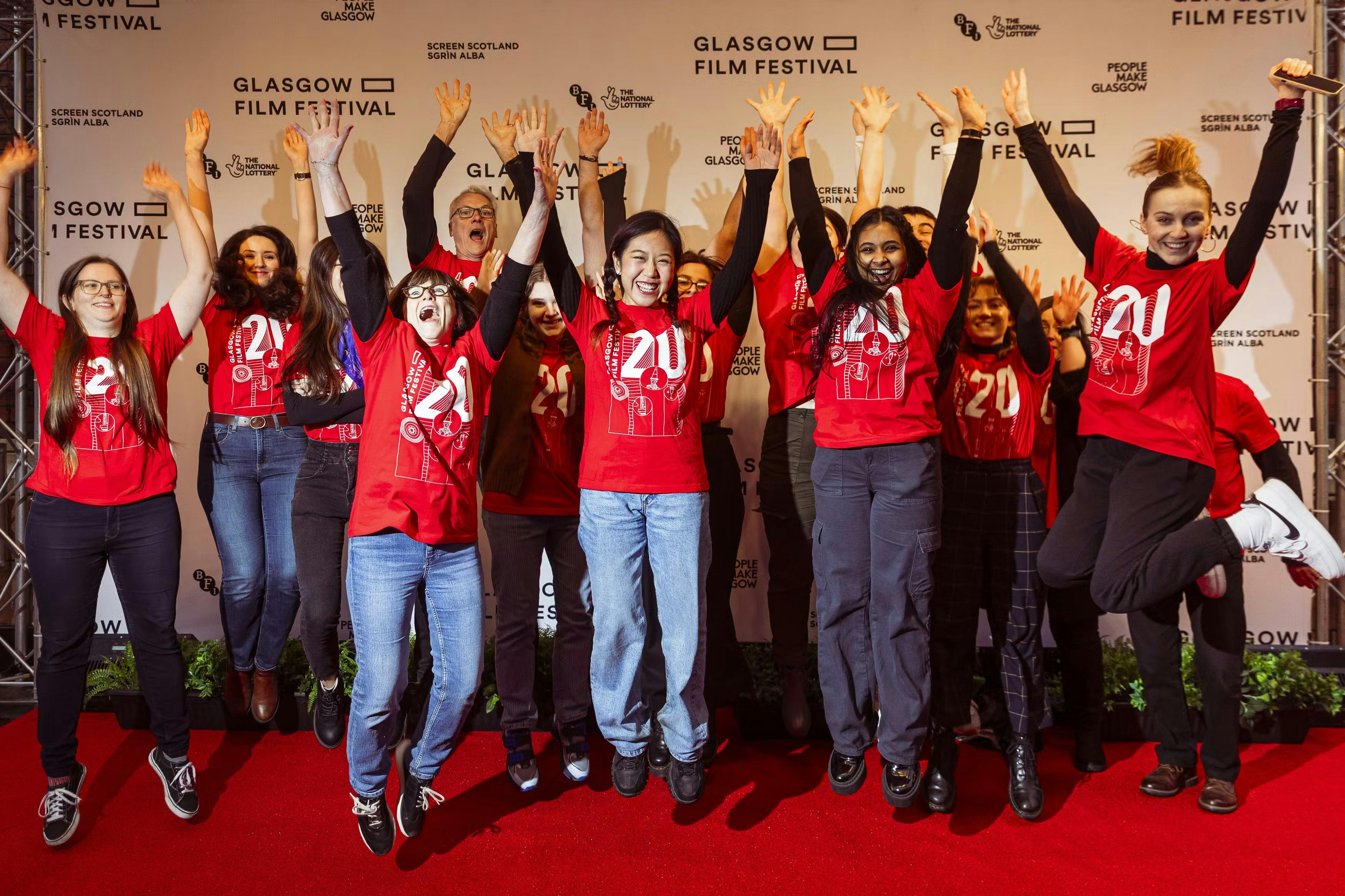 Volunteers lined up on the festival step-and-repeat