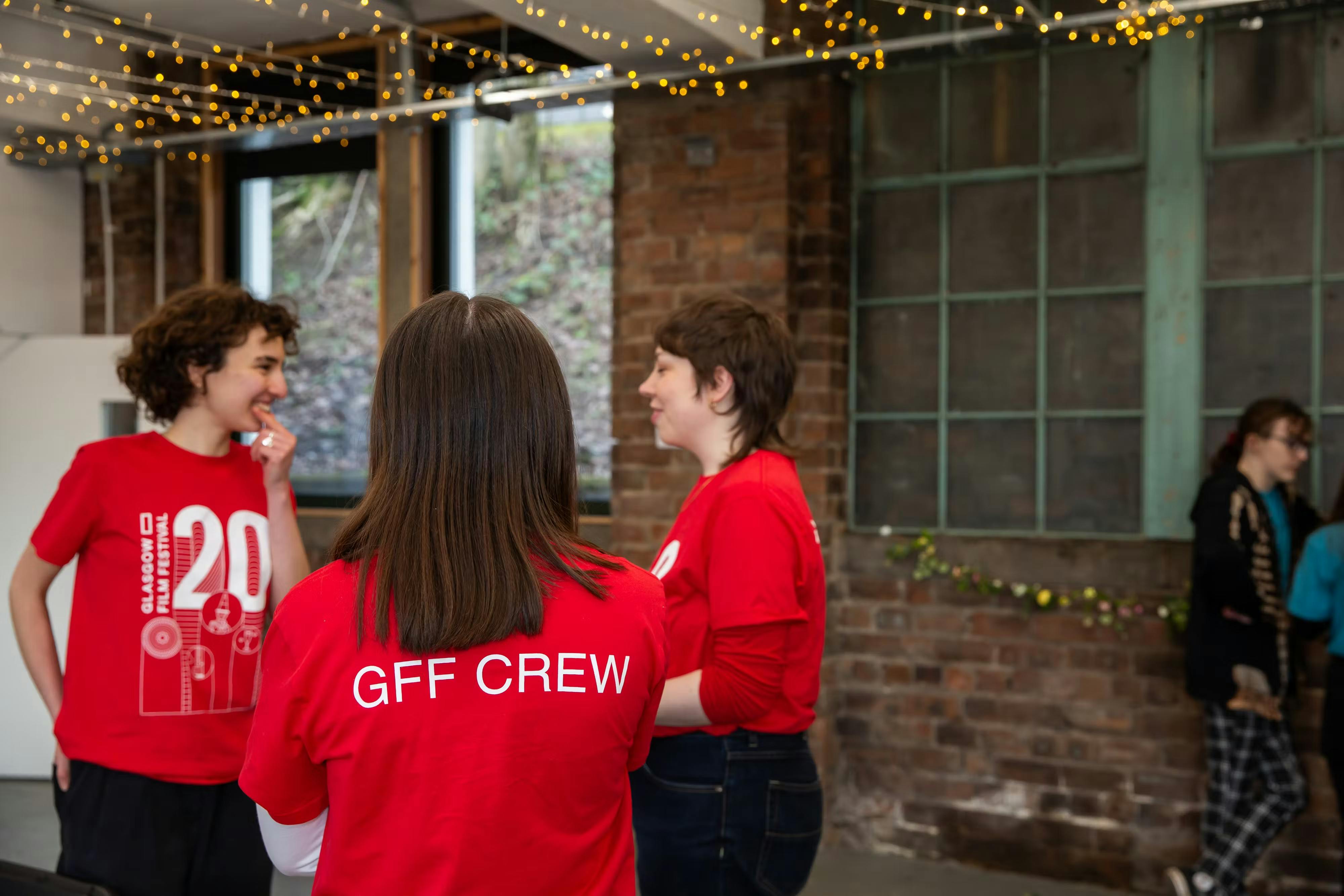 Volunteers wearing red GFF CREW shirts at an event