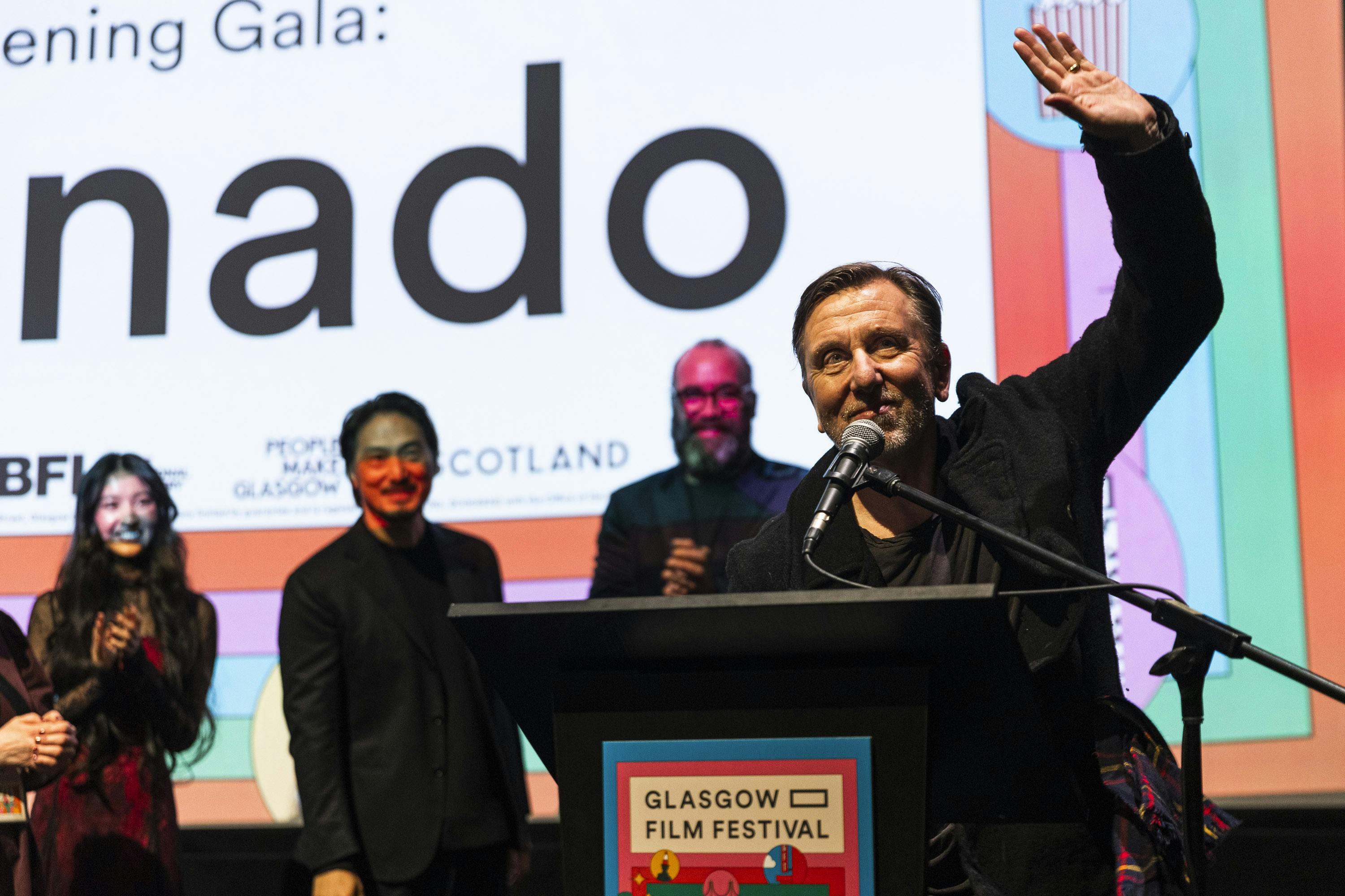 Director speaking on stage during a gala presentation