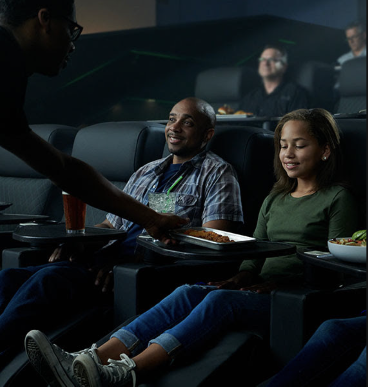 Server bringing food to guests at LOOK Cinema