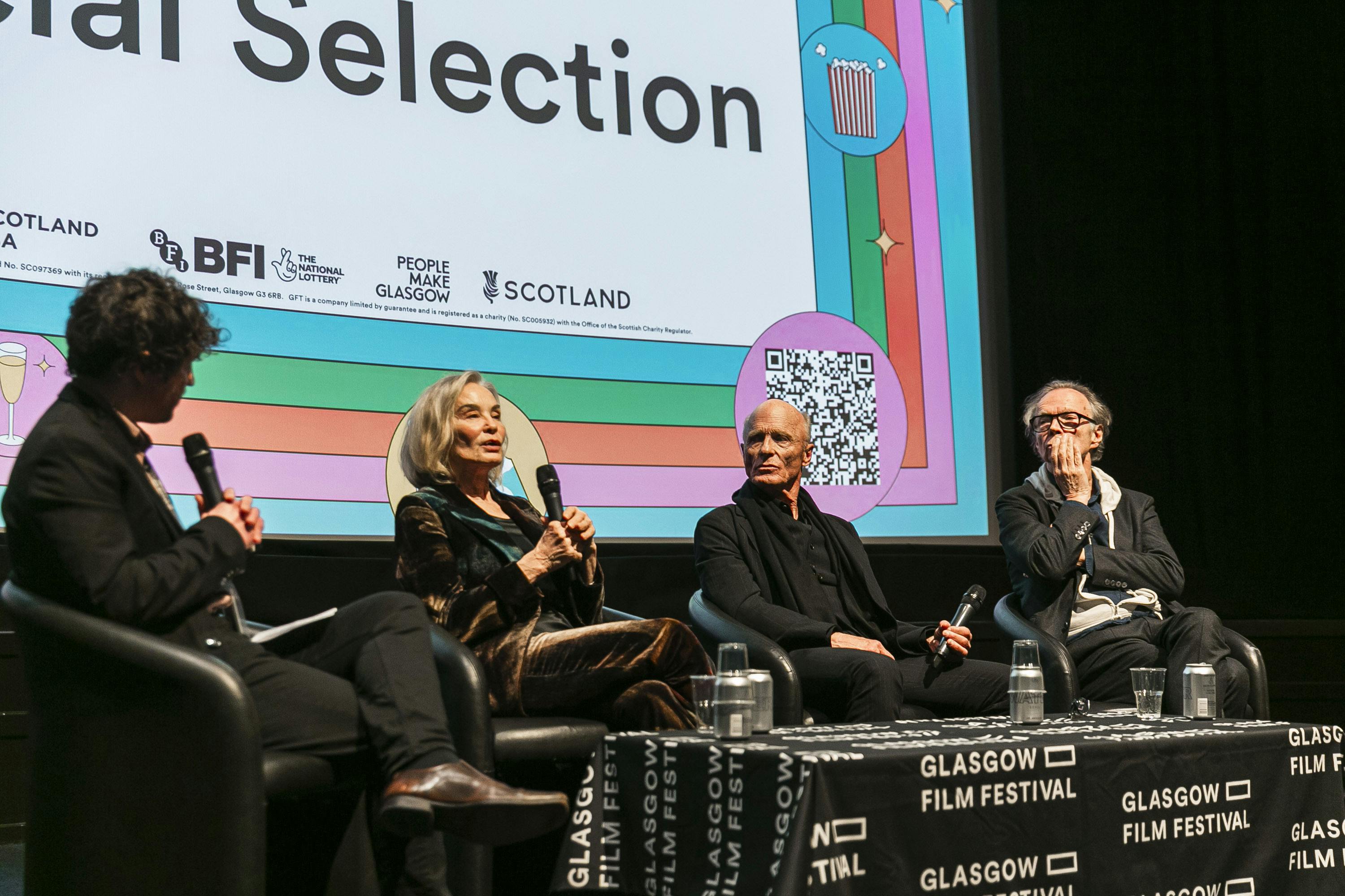 Filmmaker panel discussing a film on stage