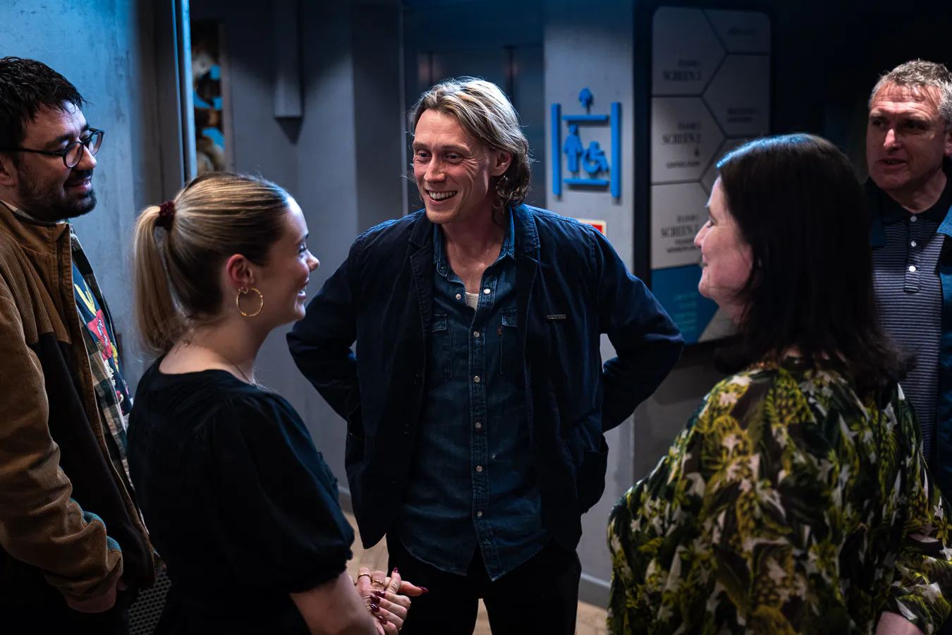 Katya Jones and Aimee Fuller smile with a screen full of guests.
