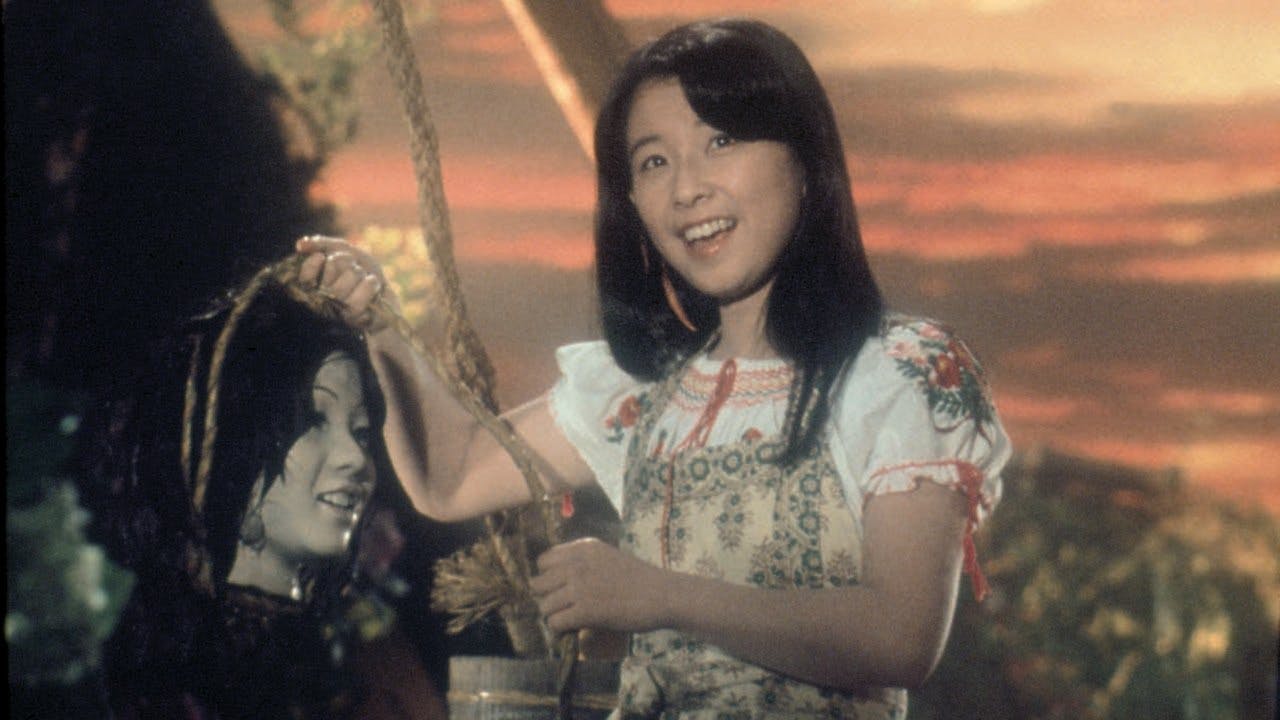 A young woman holding a severed head in House, 1977