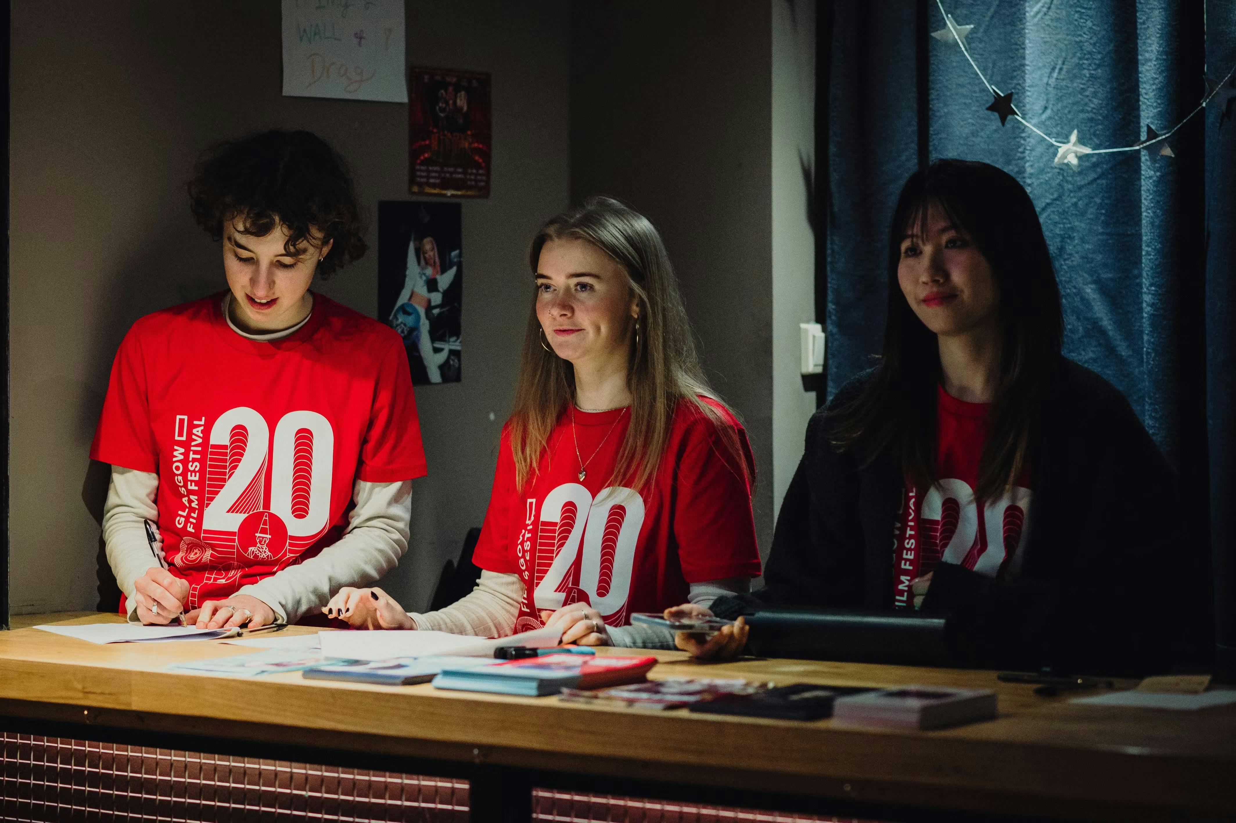 Two volunteers reviewing the programme guide