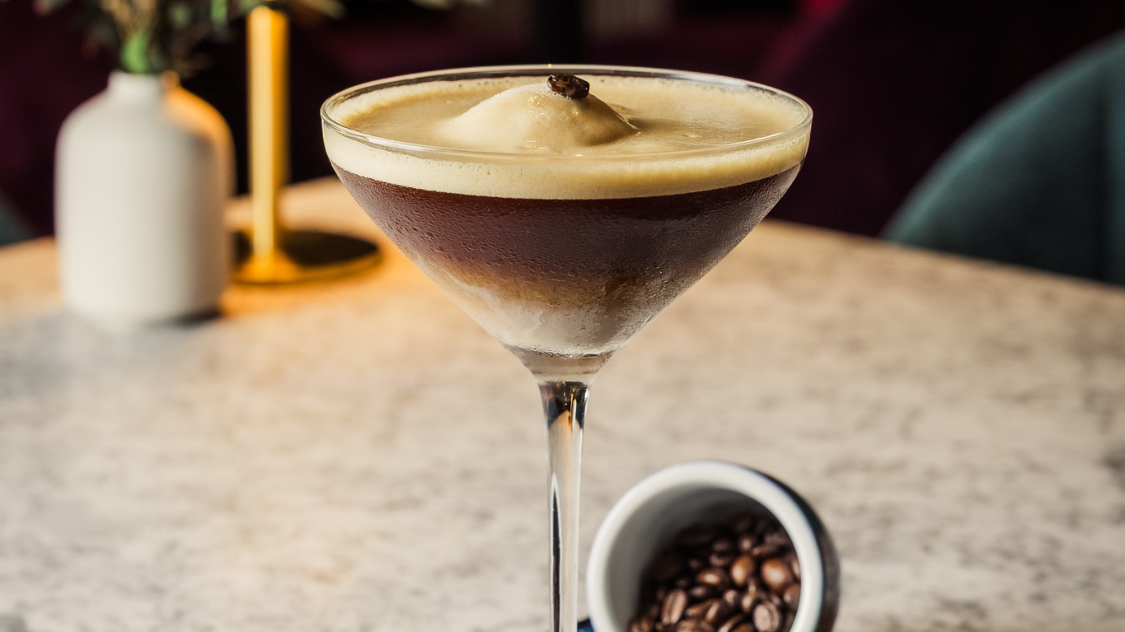 An Espresso Martini with ice cream, artfully displayed on a marble table.