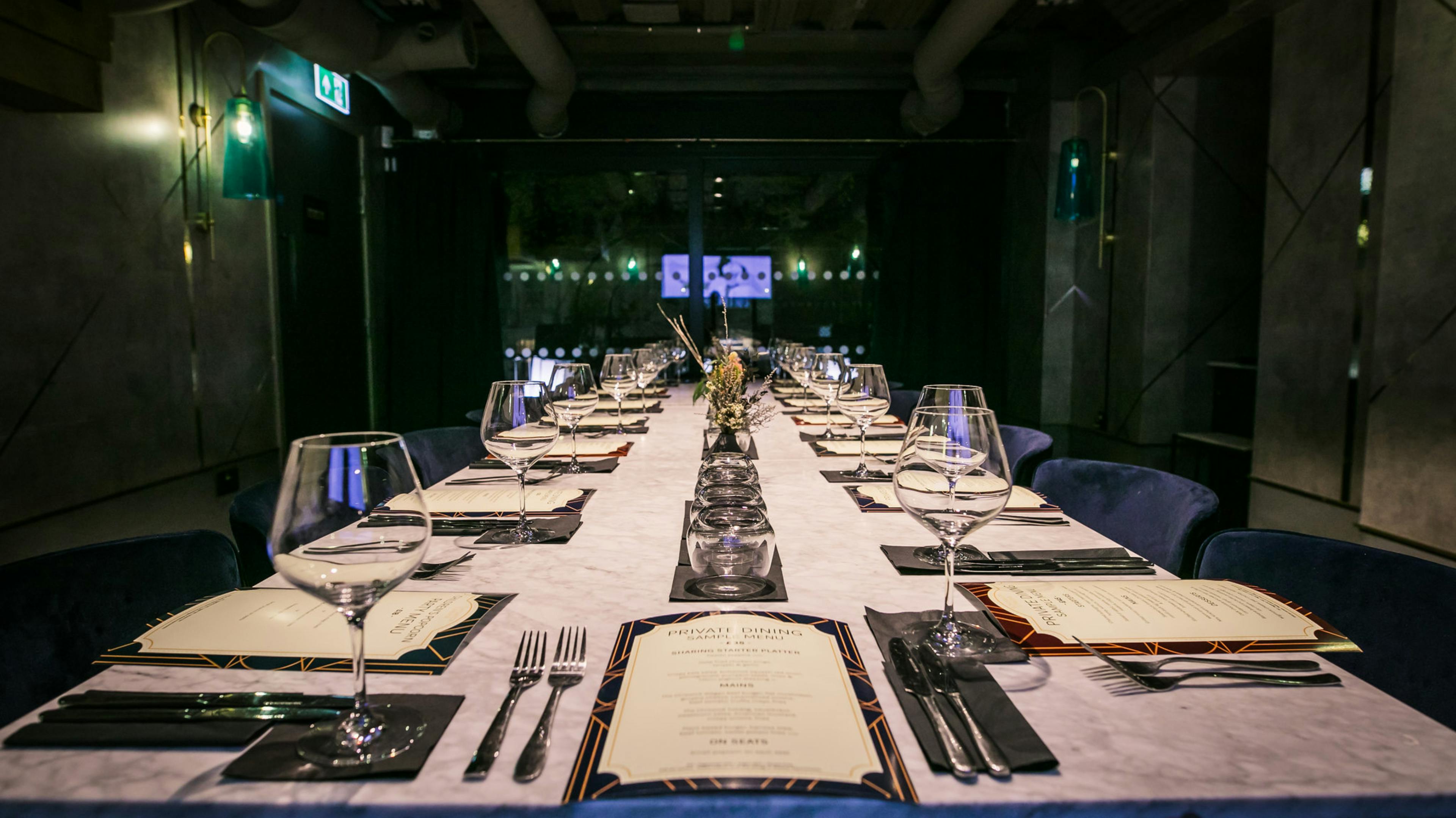 The 16 seat private dining room is set with glasses and menus ready for guests.
