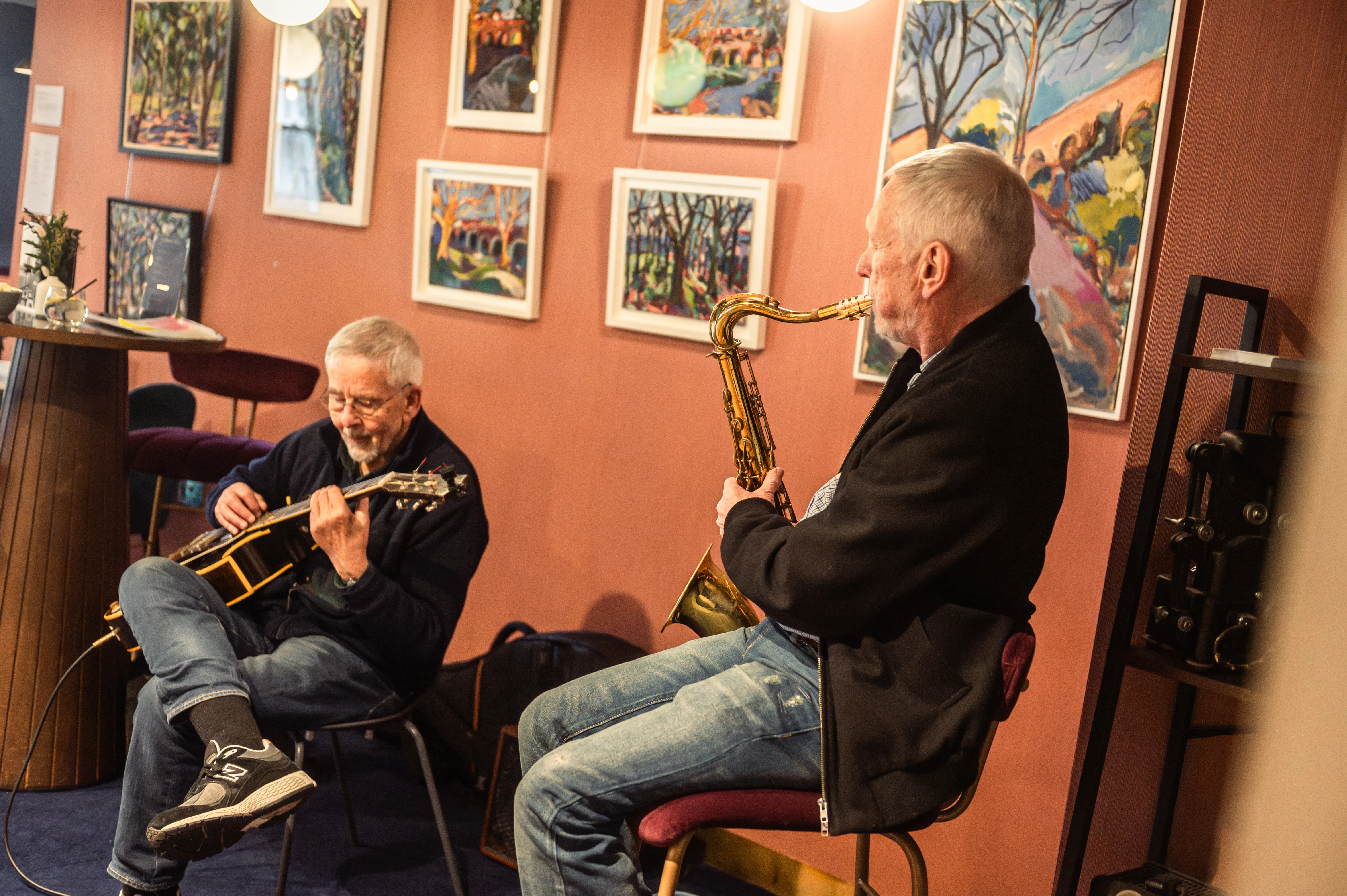 Two musicians play a guitar and an electric piano in the cinema's Lounge bar.