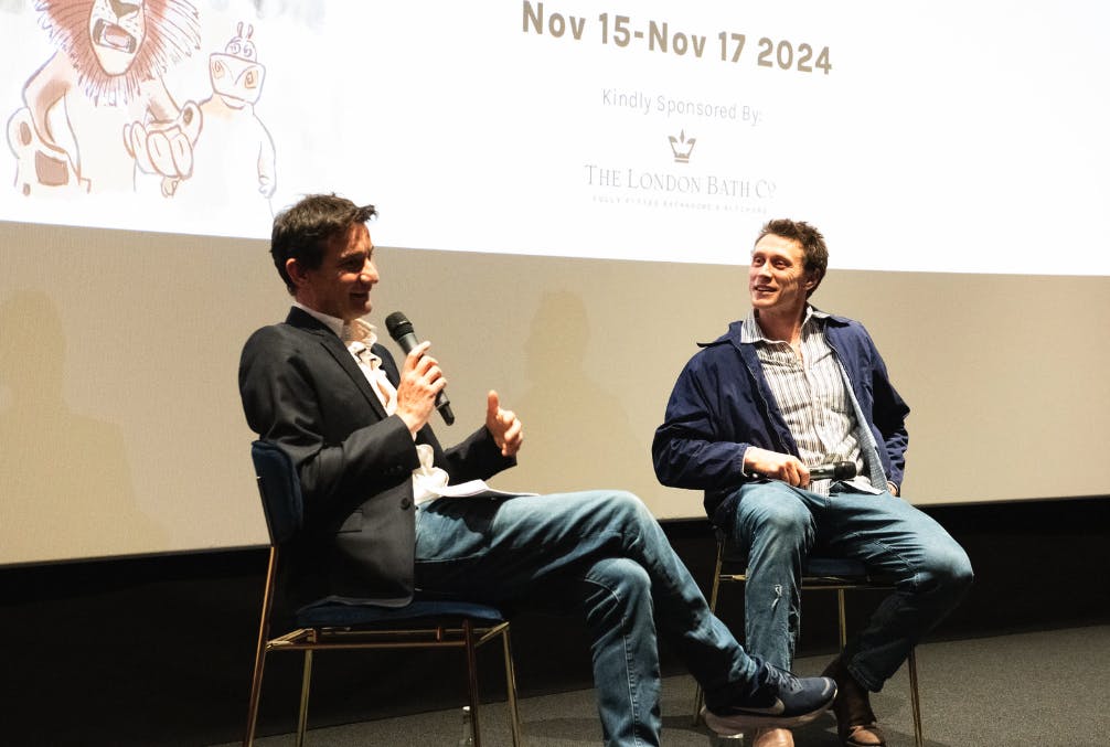 George MacKay speaks to Andrea Carnevali, smiling on stage at Chiswick Cinema.