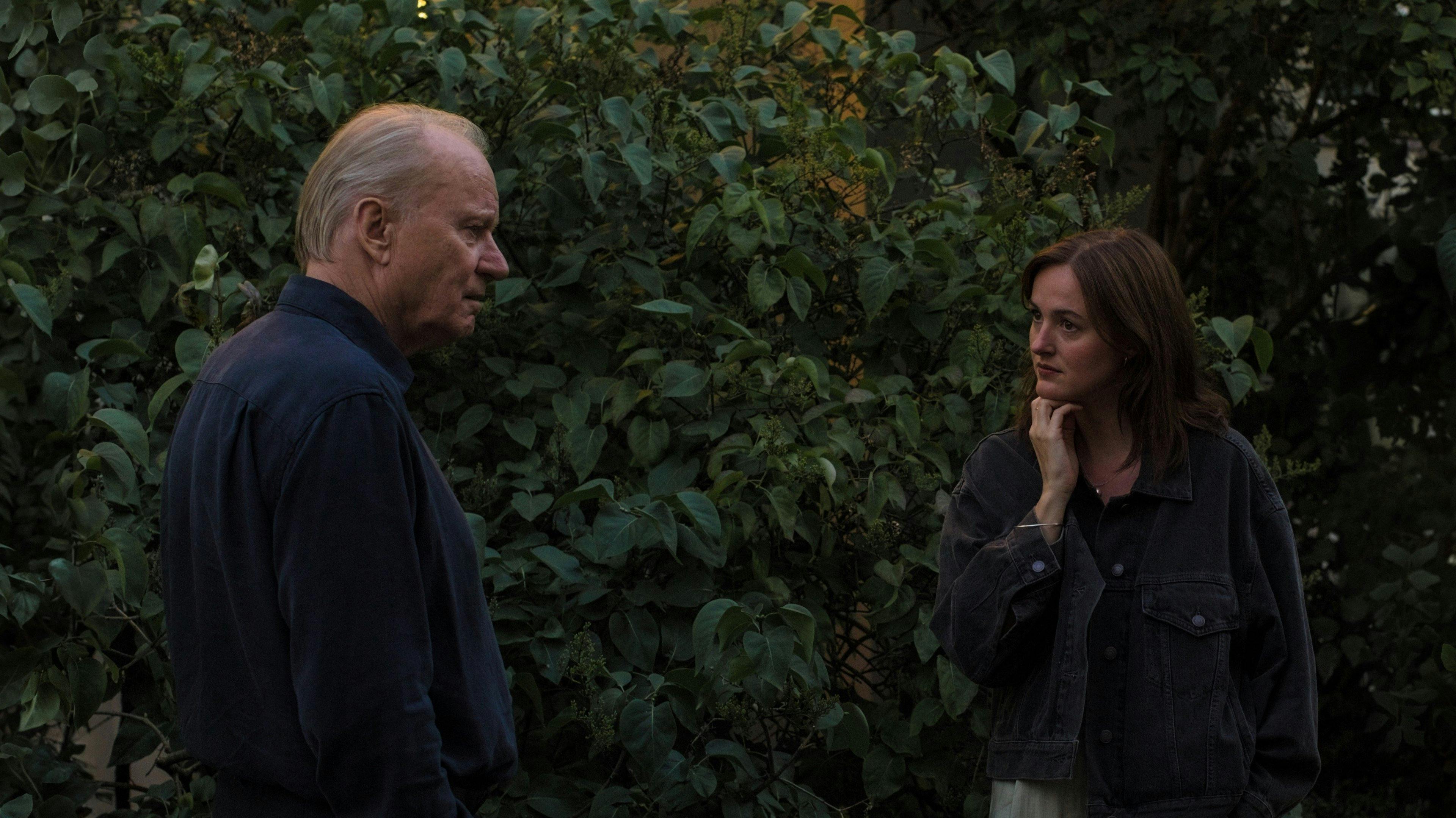 Two friends chasing floating legs in a red room from House, 1977